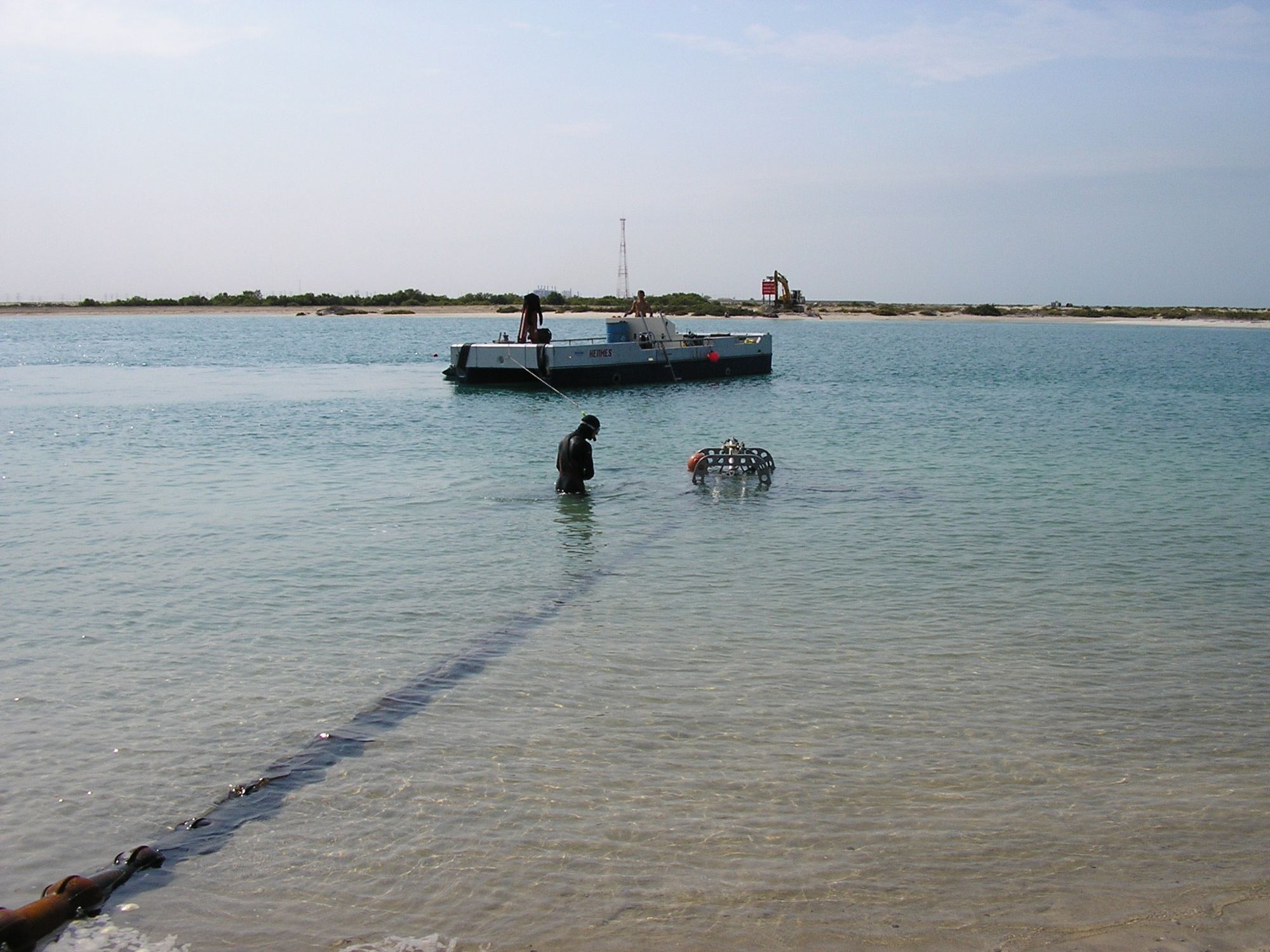 Burial pontoon and divers in shallow water